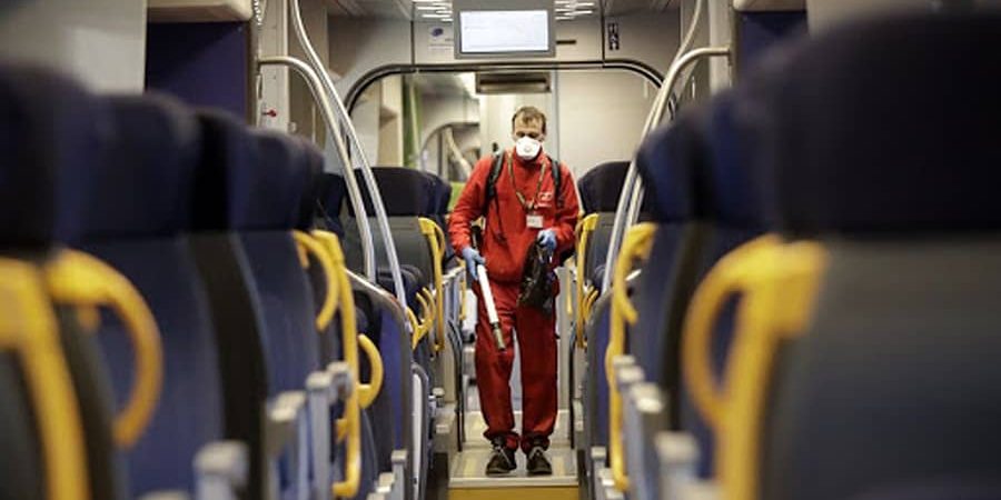 Worker sprays disinfectant on an Italian train.
